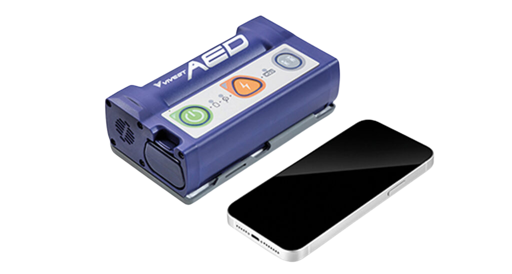 En blå ViVest Pocket AED 3 hjärtstartare bredvid mobiltelefon som visar dess lilla och bärbara storlek.